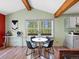 Cozy dining area featuring modern furniture, wood beams, and an eye-catching window view at 11650 Baca Rd, Conifer, CO 80433