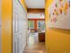 A hallway leading to the living room showcasing wood floors and brightly painted walls at 11650 Baca Rd, Conifer, CO 80433