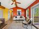 A living room boasts a vaulted ceiling, a sofa, a wood-burning fireplace, and access to the deck at 11650 Baca Rd, Conifer, CO 80433