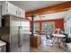 Open-concept living area showcasing a wood-burning stove and access to the outdoor deck at 11650 Baca Rd, Conifer, CO 80433