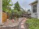 Relaxing backyard oasis featuring a stone pathway, lush plants, and a spacious deck at 745 Stowe St, Highlands Ranch, CO 80126