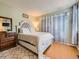Cozy bedroom with light green walls, wood floors and a large dresser at 745 Stowe St, Highlands Ranch, CO 80126