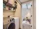 A laundry room with a view into a room with a crib and toys at 745 Stowe St, Highlands Ranch, CO 80126