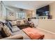 Relaxing living room with large TV, sectional sofa, and carpeted floor at 745 Stowe St, Highlands Ranch, CO 80126