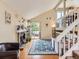 Bright living room with a brick fireplace, wooden floors, and sliding glass doors to the deck at 745 Stowe St, Highlands Ranch, CO 80126