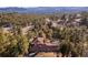 Aerial view of a private home nestled within a lush forest with mountain views at 24798 Foothills N Dr, Golden, CO 80401