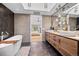 A modern bathroom featuring a soaking tub, double sink vanity and contemporary lighting at 24798 Foothills N Dr, Golden, CO 80401