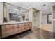 Modern bathroom featuring double sink vanity, elegant mirrors and a glass-enclosed shower at 24798 Foothills N Dr, Golden, CO 80401