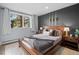 Serene bedroom featuring a cozy bed, large window with natural light, and minimalist décor at 24798 Foothills N Dr, Golden, CO 80401