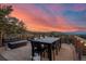 Inviting deck with mountain views, seating, dining table and string lights, perfect for entertaining at 24798 Foothills N Dr, Golden, CO 80401