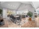 Bright dining room with hardwood floors, large windows, and views into the kitchen at 24798 Foothills N Dr, Golden, CO 80401