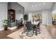 Dining room with a fireplace, hardwood floors, and access to an outdoor patio at 24798 Foothills N Dr, Golden, CO 80401