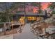 Home exterior with a mix of modern and rustic elements, featuring a rocky landscape, deck, and scenic views at 24798 Foothills N Dr, Golden, CO 80401
