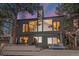 Modern home exterior featuring a wall of windows, wood accents, and a spacious deck with outdoor seating at 24798 Foothills N Dr, Golden, CO 80401