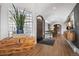 Inviting foyer with hardwood floors, a wood chest, and decorative doorway at 24798 Foothills N Dr, Golden, CO 80401