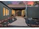 Beautiful front entrance with an arched front door, stone accents, and walkway lighting at 24798 Foothills N Dr, Golden, CO 80401