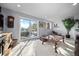 Bright living room featuring a sliding glass door to a deck with scenic views and a decorative area rug at 24798 Foothills N Dr, Golden, CO 80401