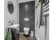 Stylish powder room with a modern vanity, mirror, and black tiled accent wall at 24798 Foothills N Dr, Golden, CO 80401
