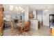 Dining area with a table, chandelier, and open view to the living room and kitchen at 3170 S Princess Cir, Broomfield, CO 80020