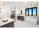 Bathroom featuring a soaking tub, double vanity, and mountain views at 11115 Evening Hunt Rd, Franktown, CO 80116