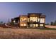 Striking modern home boasting a combination of wood, stone, and large windows at 11115 Evening Hunt Rd, Franktown, CO 80116