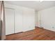 Bedroom featuring hardwood floors, double closet, and entry to another room or bath at 10 Merideth Ln, Longmont, CO 80501