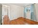 Bright bedroom with hardwood floors, double closet and a window with view of mature landscaping at 10 Merideth Ln, Longmont, CO 80501
