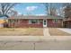 Charming brick ranch-style home with a welcoming entryway and well-maintained landscaping at 10 Merideth Ln, Longmont, CO 80501