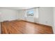 Bright living room with hardwood floors, a window, and a view of the outside at 10 Merideth Ln, Longmont, CO 80501