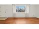 Cozy living room with hardwood floors, a large window, and neutral tones at 10 Merideth Ln, Longmont, CO 80501