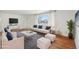 Bright, staged living room with hardwood floors, large window, and stylish furniture at 10 Merideth Ln, Longmont, CO 80501
