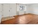 Inviting living room with hardwood floors, a large window, and tiled entryway at 10 Merideth Ln, Longmont, CO 80501