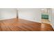 Spacious living room with hardwood floors transitioning to a kitchen area at 10 Merideth Ln, Longmont, CO 80501