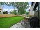 Fenced backyard with a well-maintained lawn, patio area, and outdoor seating at 5370 S Union Way, Littleton, CO 80127