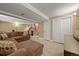 Finished basement with a plush sofa, a wet bar, and a closet storage area at 5370 S Union Way, Littleton, CO 80127