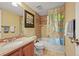 Compact bathroom featuring a peach colored vanity, toilet, and a shower with a map shower curtain at 5370 S Union Way, Littleton, CO 80127