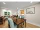 Dining room featuring hardwood floors, an accent wall and view into kitchen at 5370 S Union Way, Littleton, CO 80127