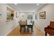 Dining room featuring hardwood floors, a wooden table, and an open view to the kitchen at 5370 S Union Way, Littleton, CO 80127