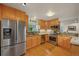 Kitchen featuring stainless steel appliances, wood cabinets, granite countertops and hardwood floors at 5370 S Union Way, Littleton, CO 80127