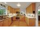 Bright kitchen featuring stainless steel appliances, granite countertops, and wood cabinets at 5370 S Union Way, Littleton, CO 80127