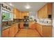 Bright kitchen featuring stainless steel appliances, granite countertops, and wood cabinets at 5370 S Union Way, Littleton, CO 80127