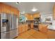 Well-lit kitchen with stainless steel appliances, wood cabinets, and stone countertops at 5370 S Union Way, Littleton, CO 80127