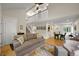 Inviting living room features an open floor plan, hardwood floors, and a staircase at 5370 S Union Way, Littleton, CO 80127