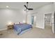 Spacious main bedroom featuring a ceiling fan, adjacent bathroom and walk-in closet at 5370 S Union Way, Littleton, CO 80127