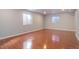 Finished basement room with hardwood floors and windows at 6055 W Warren Pl, Lakewood, CO 80227