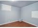 Finished basement room with hardwood floors and access panel at 6055 W Warren Pl, Lakewood, CO 80227