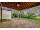 Inviting backyard patio with a wooden pergola, offering a tranquil outdoor retreat amidst lush greenery and natural beauty at 3015 Pierce St, Wheat Ridge, CO 80214