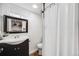 Well-lit bathroom featuring a stylish vanity, mirror, toilet and a shower with curtain at 3015 Pierce St, Wheat Ridge, CO 80214
