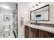 Bathroom featuring a dark wood vanity, sleek fixtures, and a walk-in shower at 3015 Pierce St, Wheat Ridge, CO 80214