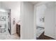 Hallway view of a bathroom featuring a dark vanity, shower, and modern fixtures at 3015 Pierce St, Wheat Ridge, CO 80214